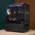 Destello Luz black gaming PC, three-quarter angle showing tempered glass side panel with RGB lighting and internal components