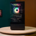 Destello Luz black gaming PC front view showing RGB CPU cooler fan through mesh front panel